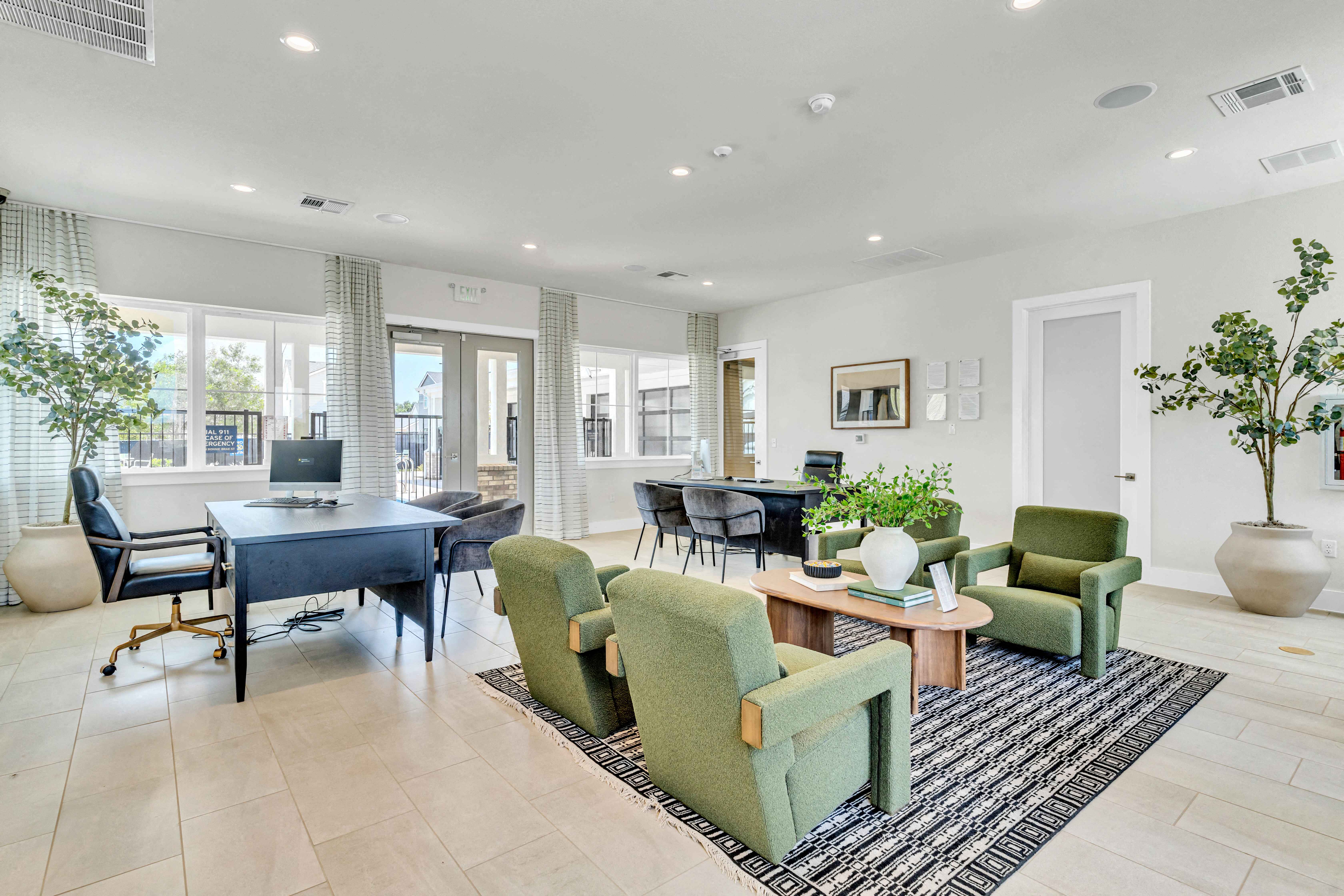 a living room with a couch and chairs and a table